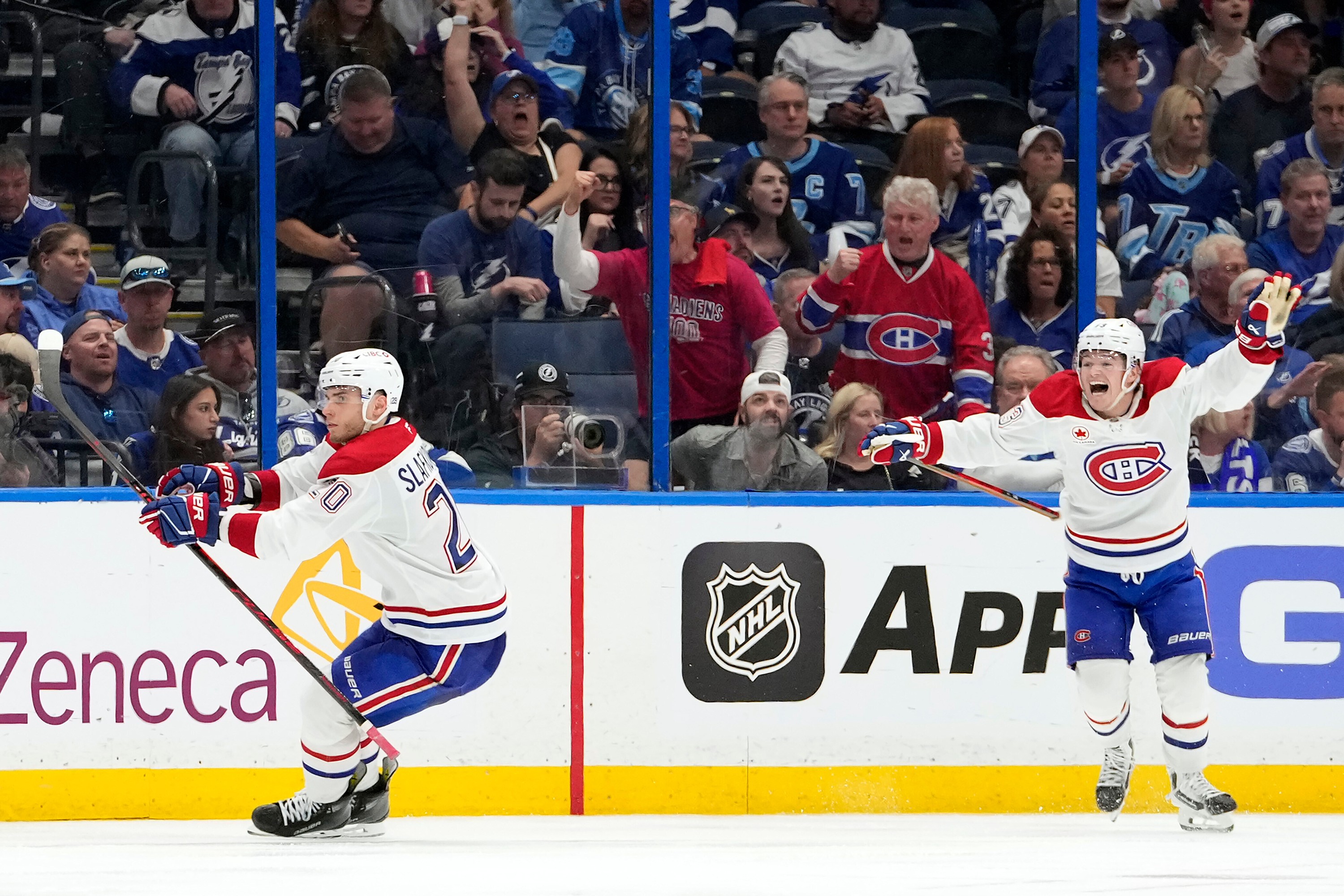 Canadiens wingers Juraj Slafkovsky, left, and Cole Caufield celebrate Slafkovsky's Game 1 overtime goal on Sunday in Tampa, Fla.