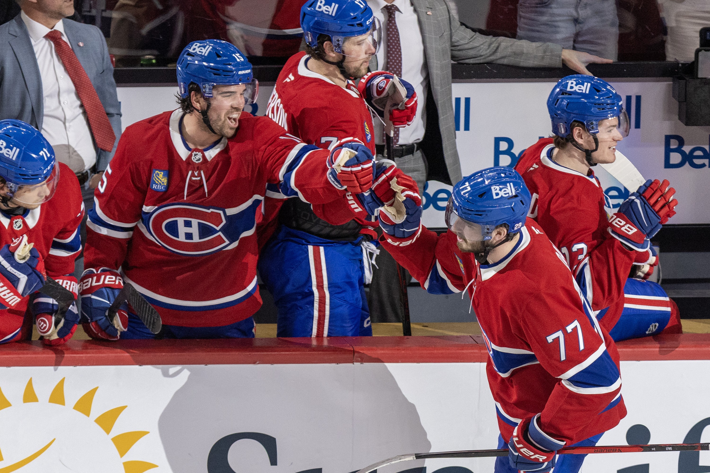 Canadiens' Kirby Dach gets glove taps from teammates on the bench after scoring.
