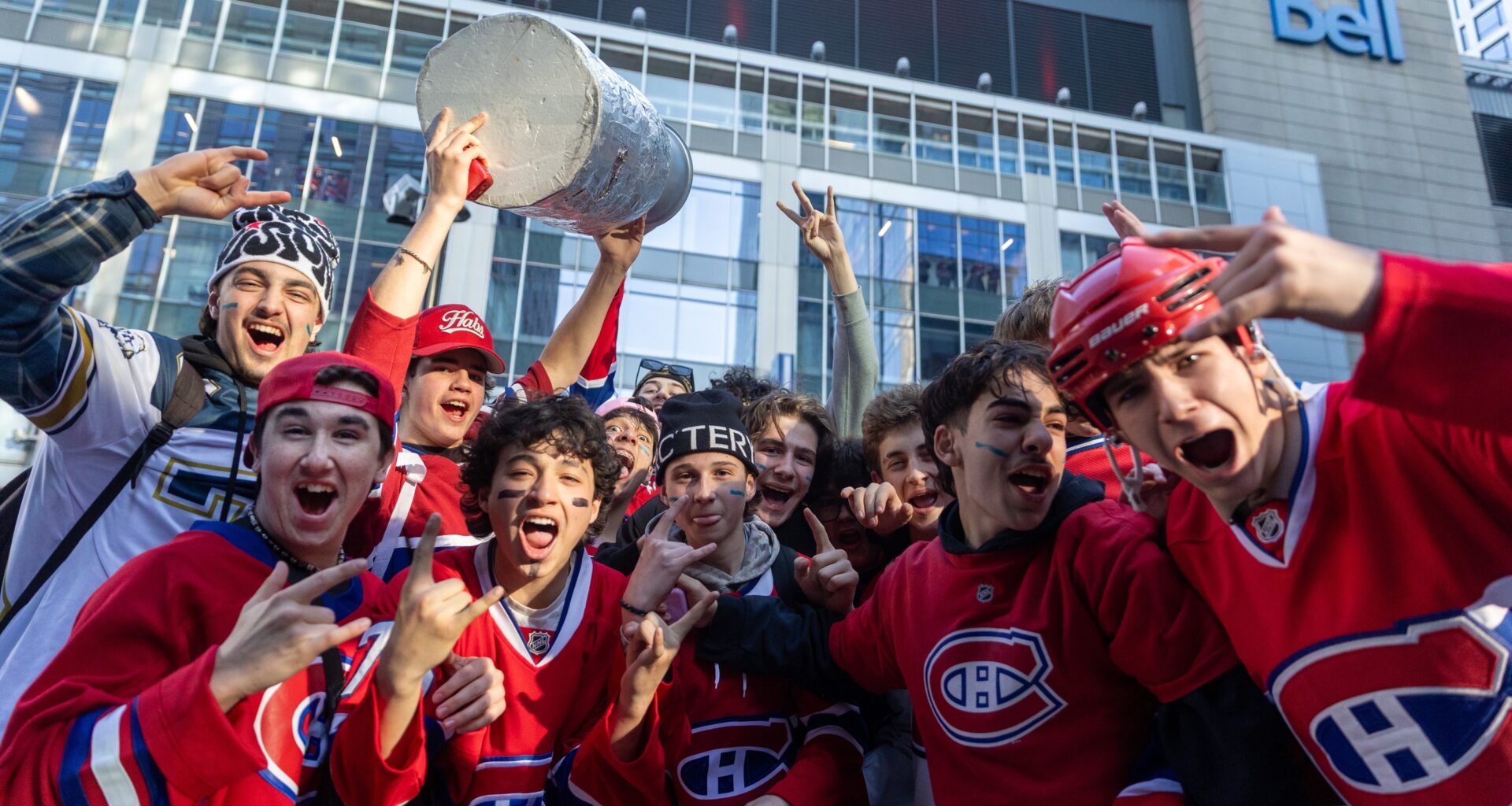 Canadiens fans throng outside the Bell Centre before Game 3, one holding aloft a replica Stanley Cup.