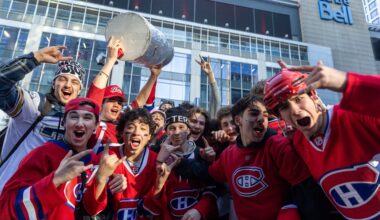 Canadiens fans throng outside the Bell Centre before Game 3, one holding aloft a replica Stanley Cup.