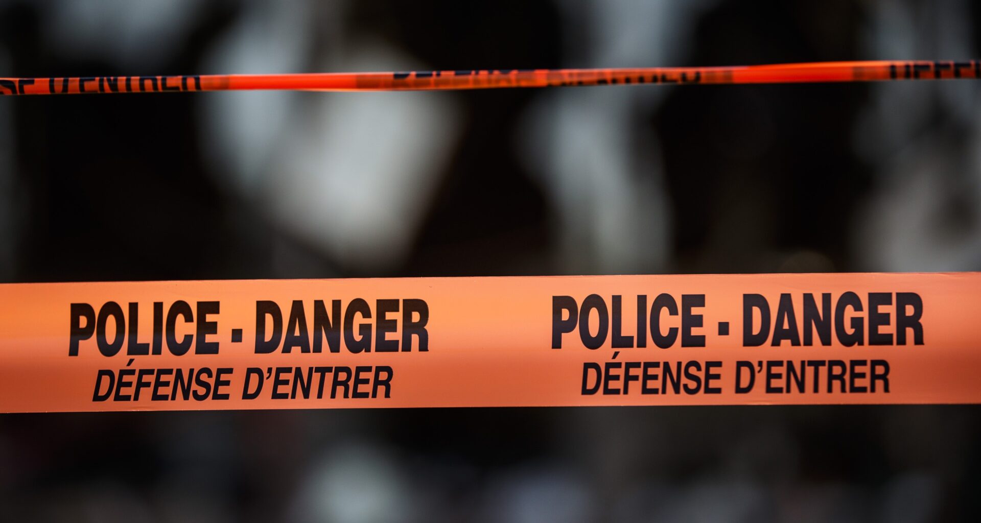 Bilingual messages on police tape.