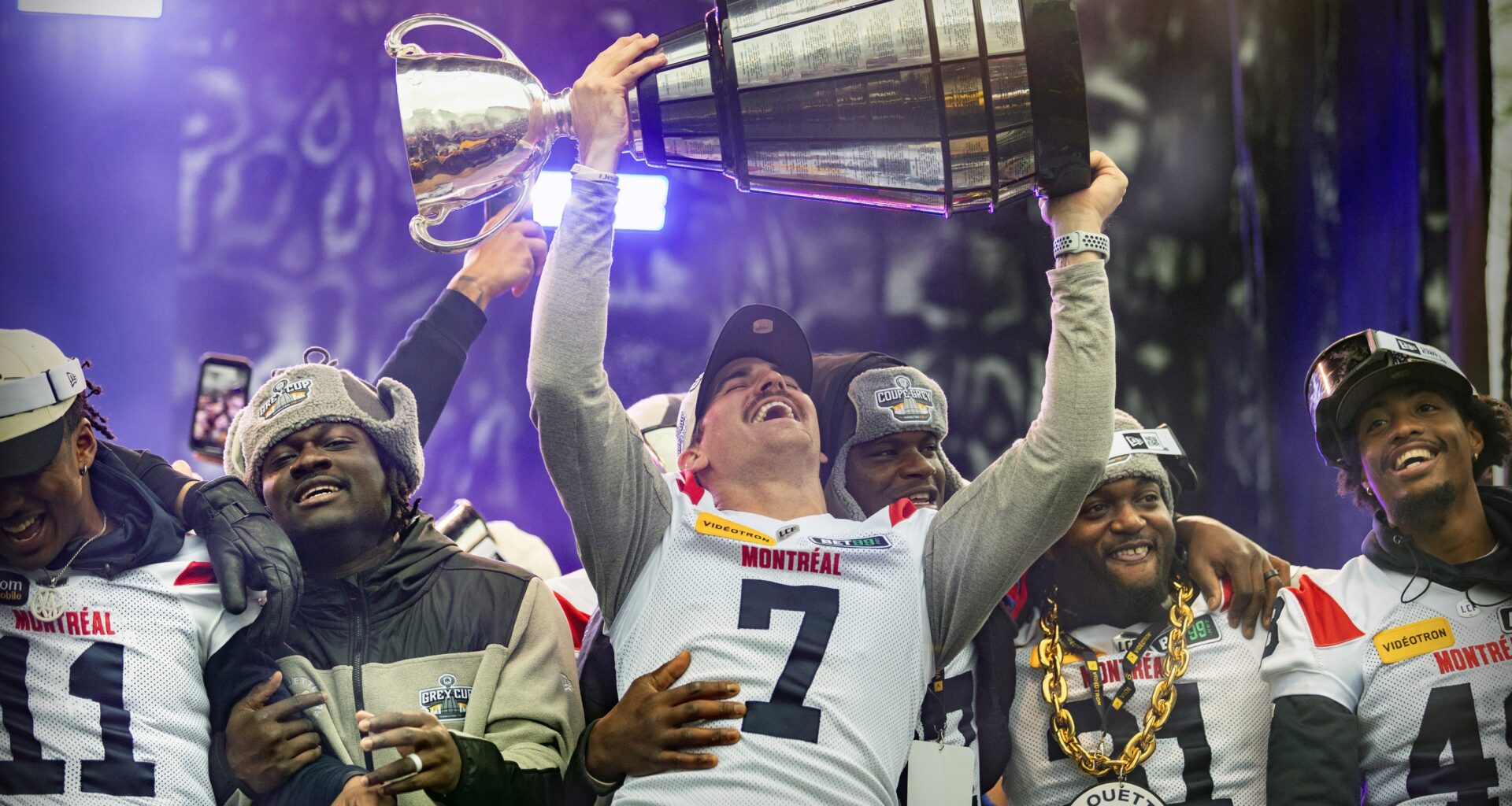 Alouettes quarterback Cody Fajardo raises the Grey Cup while celebrating with teammates Kaion Julien-Grant, left, Jeshrun Antwi, William Stanback and Kabion Ento, right, after their parade in Montreal on Nov. 22, 2023.