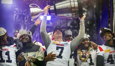 Alouettes quarterback Cody Fajardo raises the Grey Cup while celebrating with teammates Kaion Julien-Grant, left, Jeshrun Antwi, William Stanback and Kabion Ento, right, after their parade in Montreal on Nov. 22, 2023.