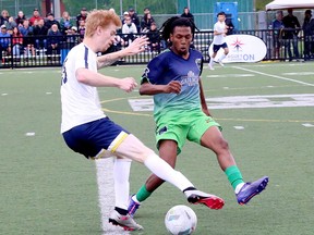 Sudbury Cyclones striker Jaiden Santo, right, battles for a ball against Whitby FC defender Russell Robertson.