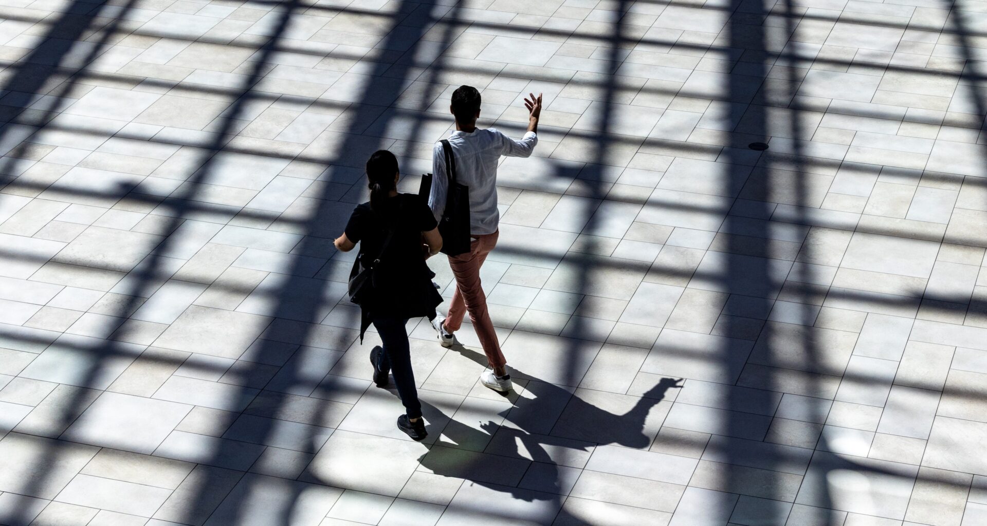 A couple walk through the sunlight coming from skylights at the Royalmount shopping mall in Montreal Sunday Aug. 31, 2025.