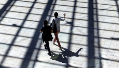 A couple walk through the sunlight coming from skylights at the Royalmount shopping mall in Montreal Sunday Aug. 31, 2025.