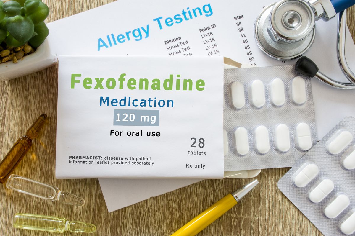 Fexofenadine medication as antihistamine drug concept photo. On doctor table is pack with words "Fexofenadine medication" and pills for treatment of allergy