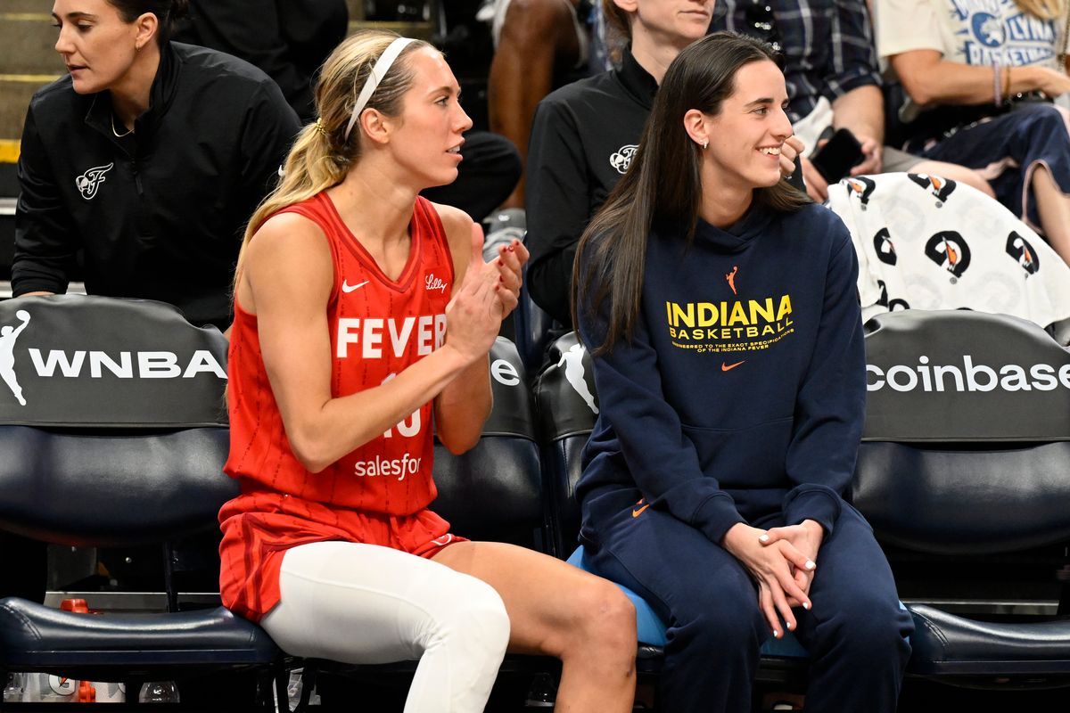 Lexie Hull and Caitlin Clark sit together on the bench