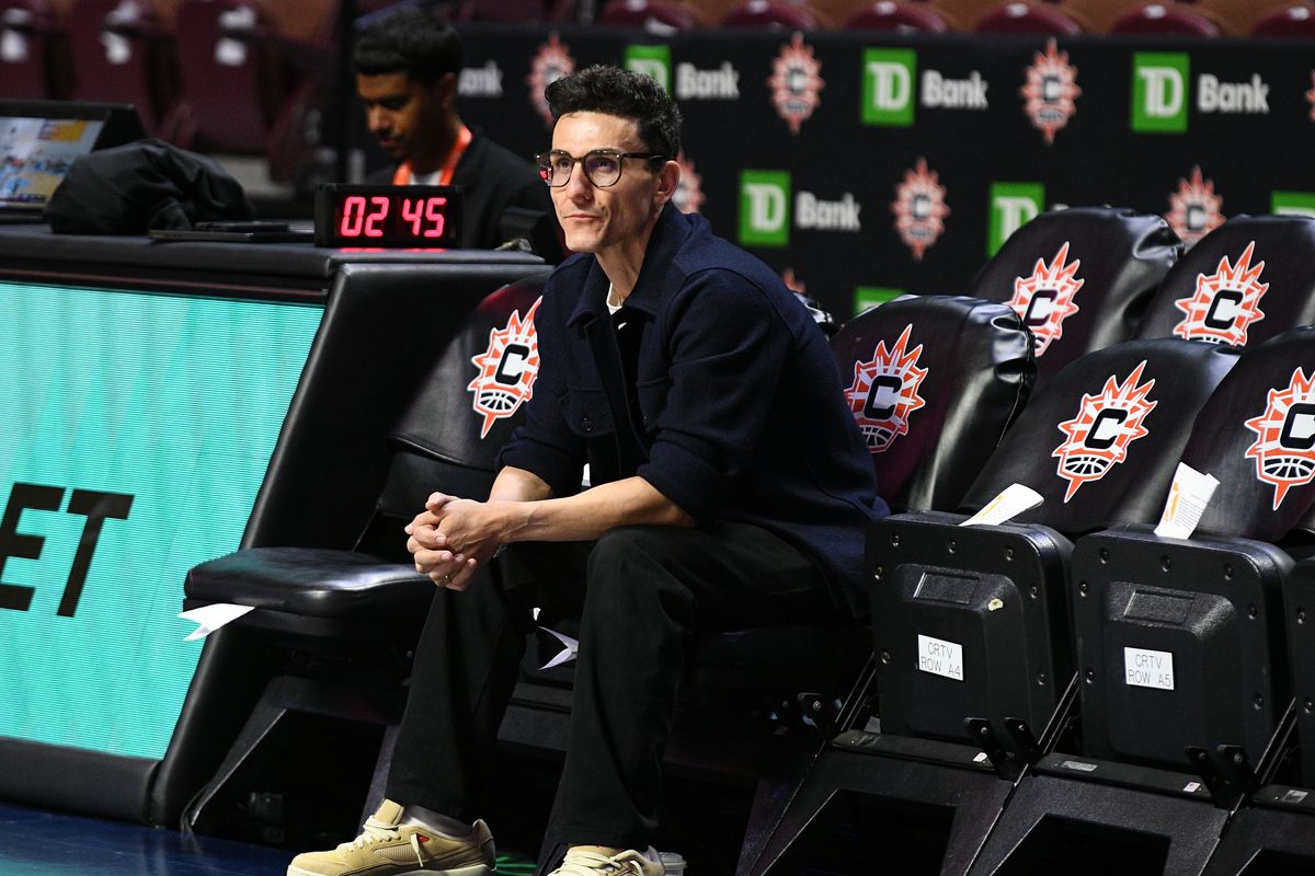 Jonathan Kolb, General Manager of the New York Liberty, watches Liberty players warm up before a WNBA game between the New York Liberty and the Connecticut Sun on August 3, 2025, at Mohegan Sun Arena in Uncasville, CT