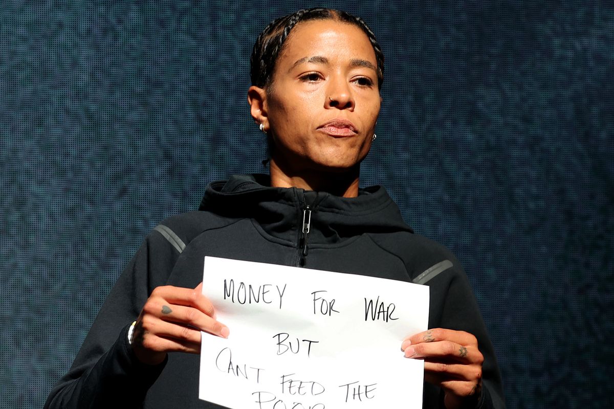 Natasha Cloud #15 of the Phantom holds a sign that reads "Money for war but can't feed the poor" during her introduction prior to playing the Unrivaled 2026 Championship game against the Mist at Sephora Arena on March 4, 2026 in Medley, Florida