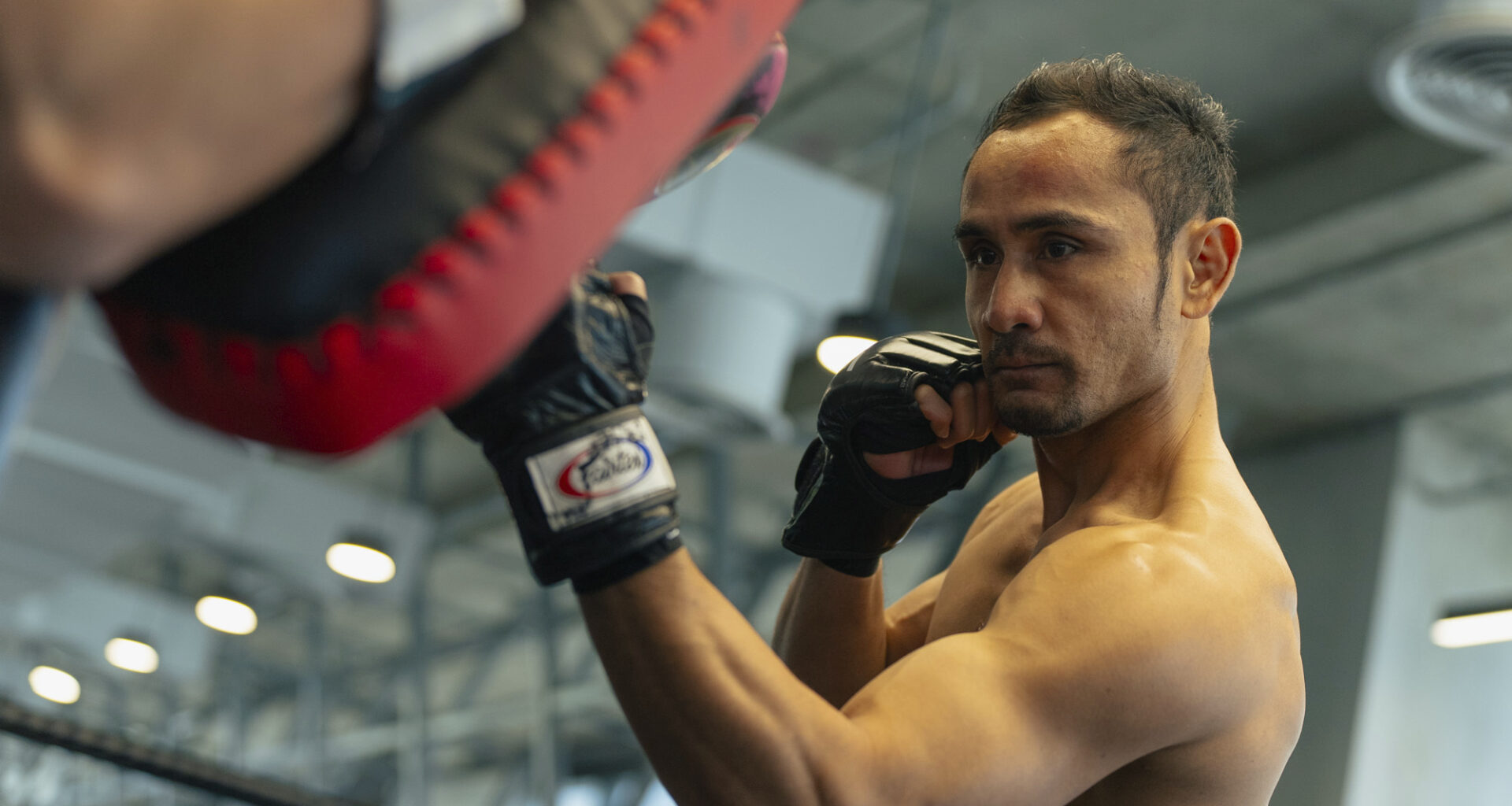 Muay Thai legend Sam A Gaiyanghadao punches the pads at Evolve MMA