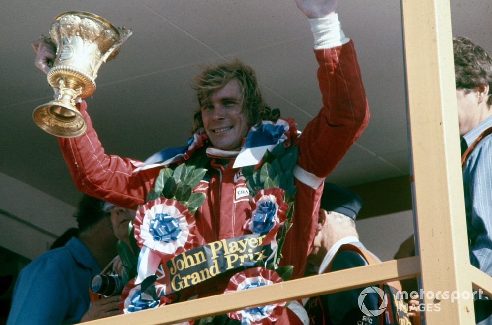James Hunt celebrates victory on the podium. He would late be disqualified from the results.