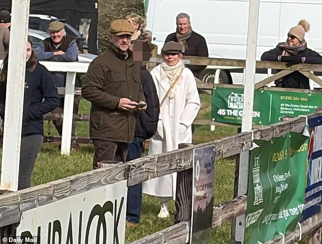 Geri Halliwell, dressed all in white, arrives at a point-to-point racing event at Edgcote with husband Christian Horner (to her left in brown cap)