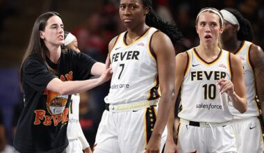 Indiana Fever star Aliyah Boston (center) has agreed a new four-year, $6.3m deal with the team