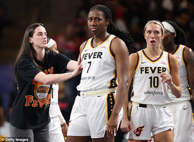 Indiana Fever star Aliyah Boston (center) has agreed a new four-year, $6.3m deal with the team