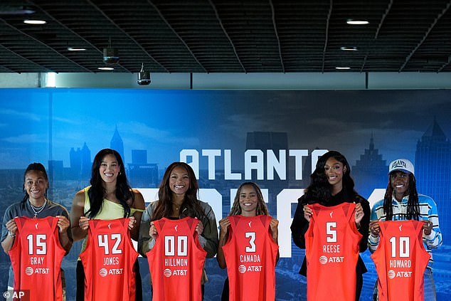 Atlanta Dream's Allisha Gray, Brionna Jones, Naz Hillmon, Jordin Canada, Angel Reese and Rhyne Howard hold up their jerseys