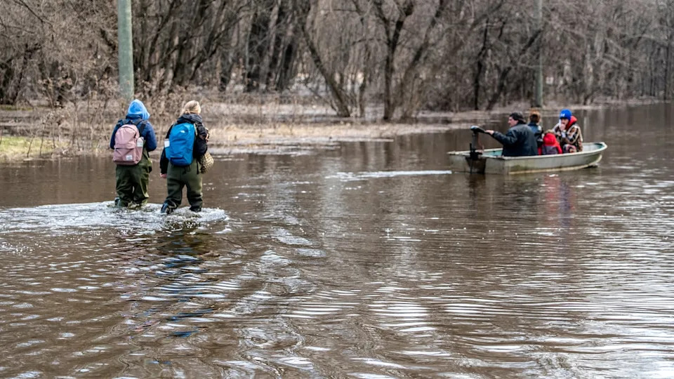 Residents in Gatineau trek through knee-deep water on April 21, 2026.