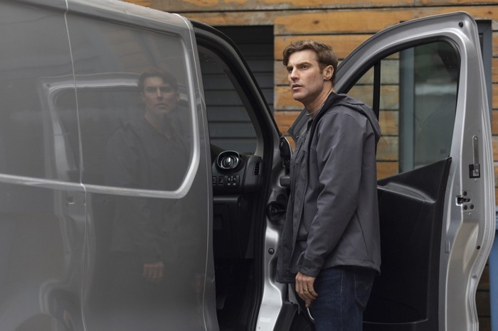 Theo stands beside his van in Coronation Street