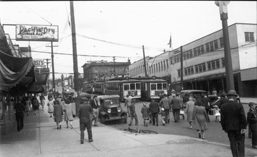 1946: Streetcars 150 and 155, Capilano and Lonsdale lines, at foot of Lonsdale Avenue. Also seen are the Burrard Dry Dock offices and the Sugar Bowl restaurant sign.