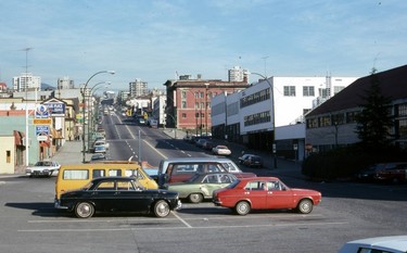 1978: Looking north up Lonsdale Avenue. Several cars are parked in a parking lot, with signs for Delo's Place and the Mayflower Restaurant seen in the background.