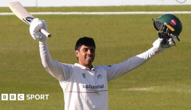 Rishi Patel raises his arms after scoring a century for Leicestershire