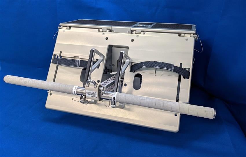 A white handle attached to a cable coming out of a silver metal box.