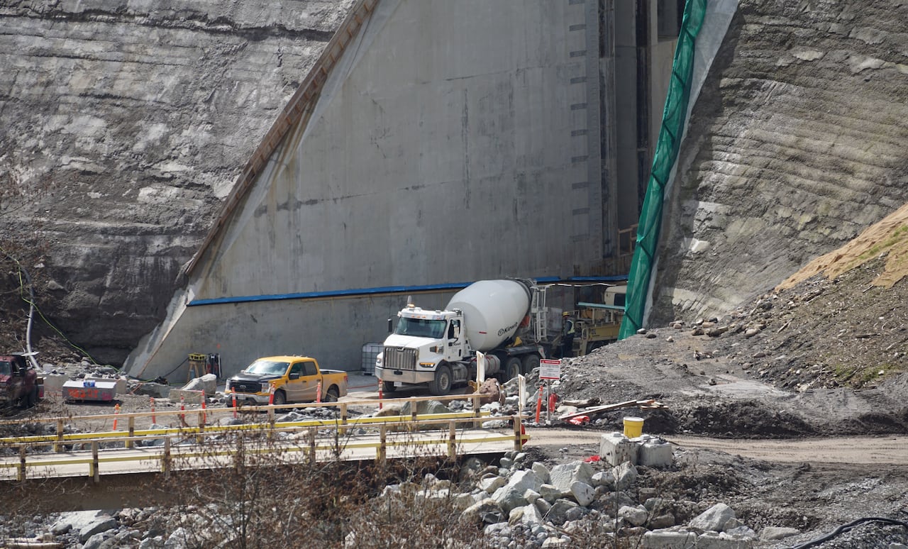 A cement truck parked in a giant concrete dam.