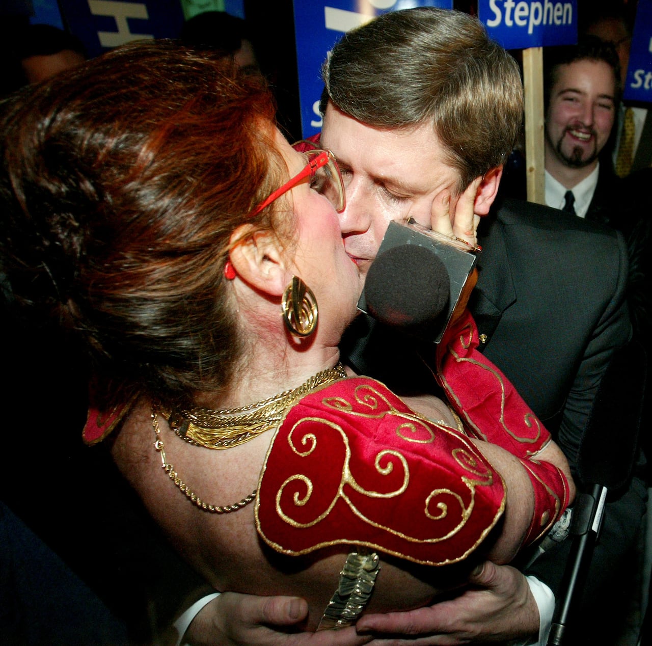 A woman and a man are kissing.