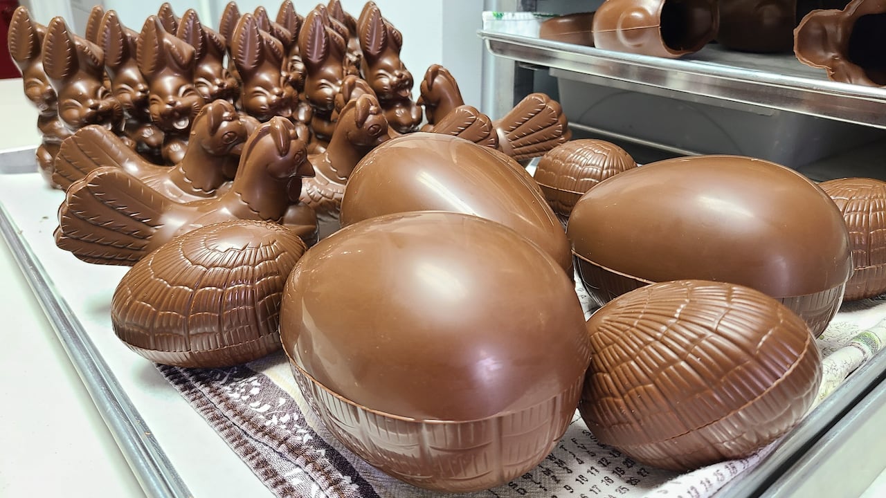 Chocolate Easter eggs, hens and bunnies on display at a chocolate shop.