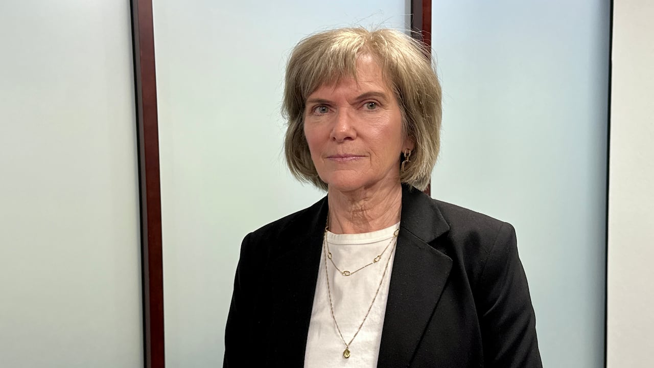 A portrait of a woman in an office.