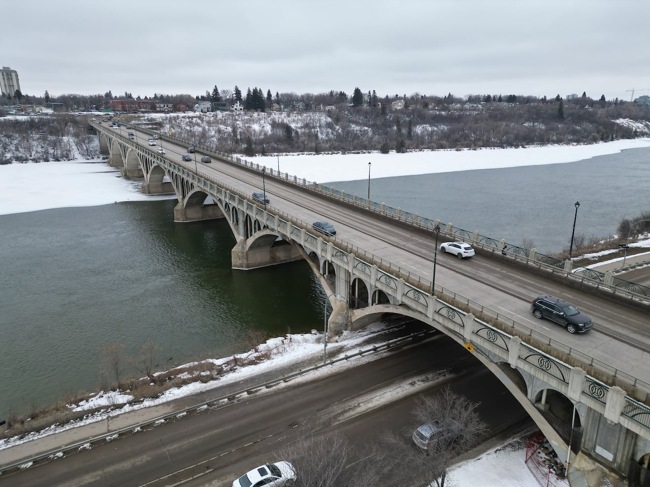 a bridge across a river is seen from above in winter