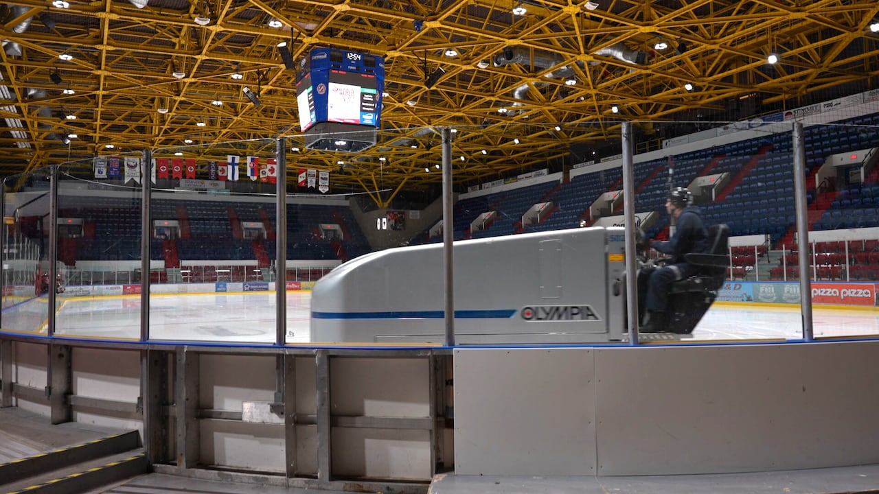 An ice resurfacing machine works on a junior hockey arena.