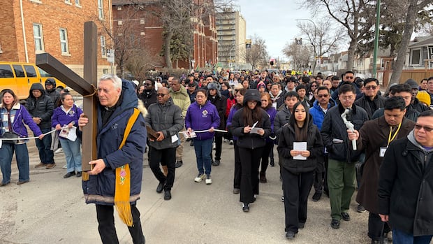 Winnipeg Catholics commemorate going through 'darkness to come to the light' in annual Way of the Cross walk