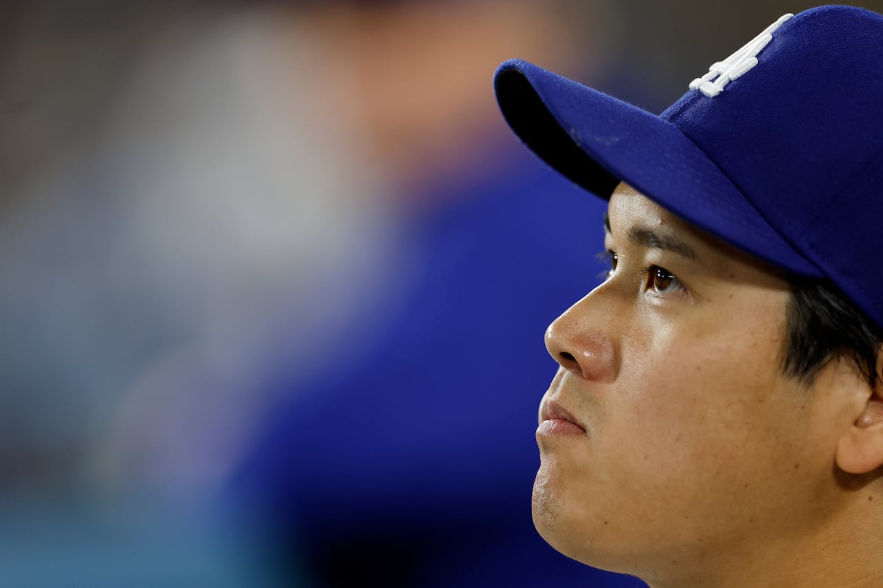 The face of Los Angeles Dodgers star Shohei Ohtani, seen as he sits in the dugout