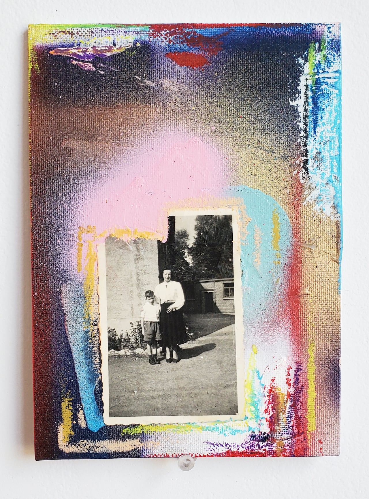 A colourful painting with a black and white photo on the front of it.