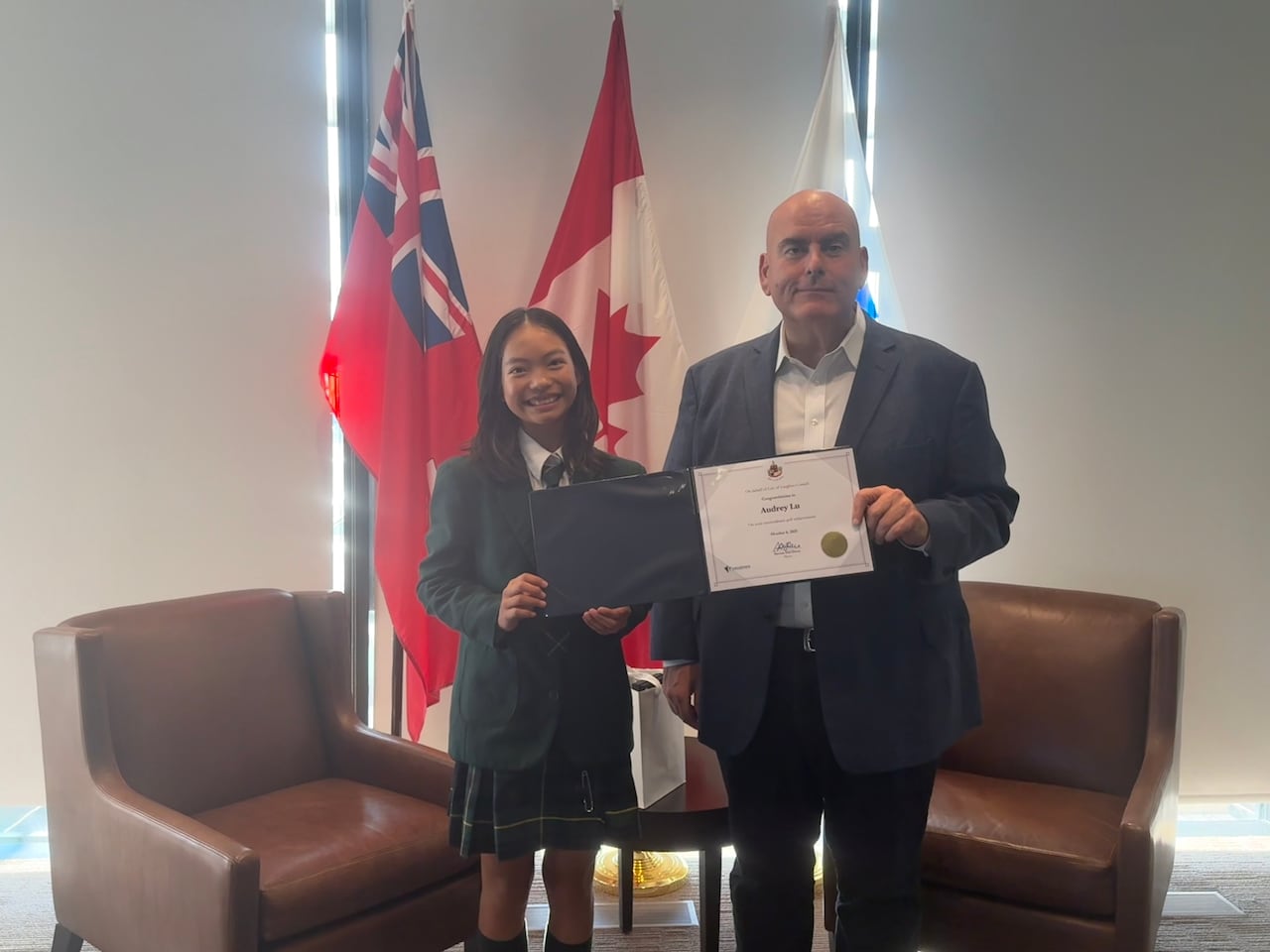 Golfer Audrey Lu poses for a photo next to Vaughan Mayor Steven Del Duca.
