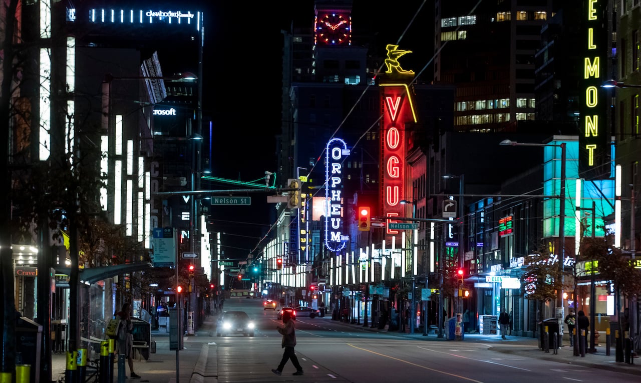 A street with a number of neon signs.