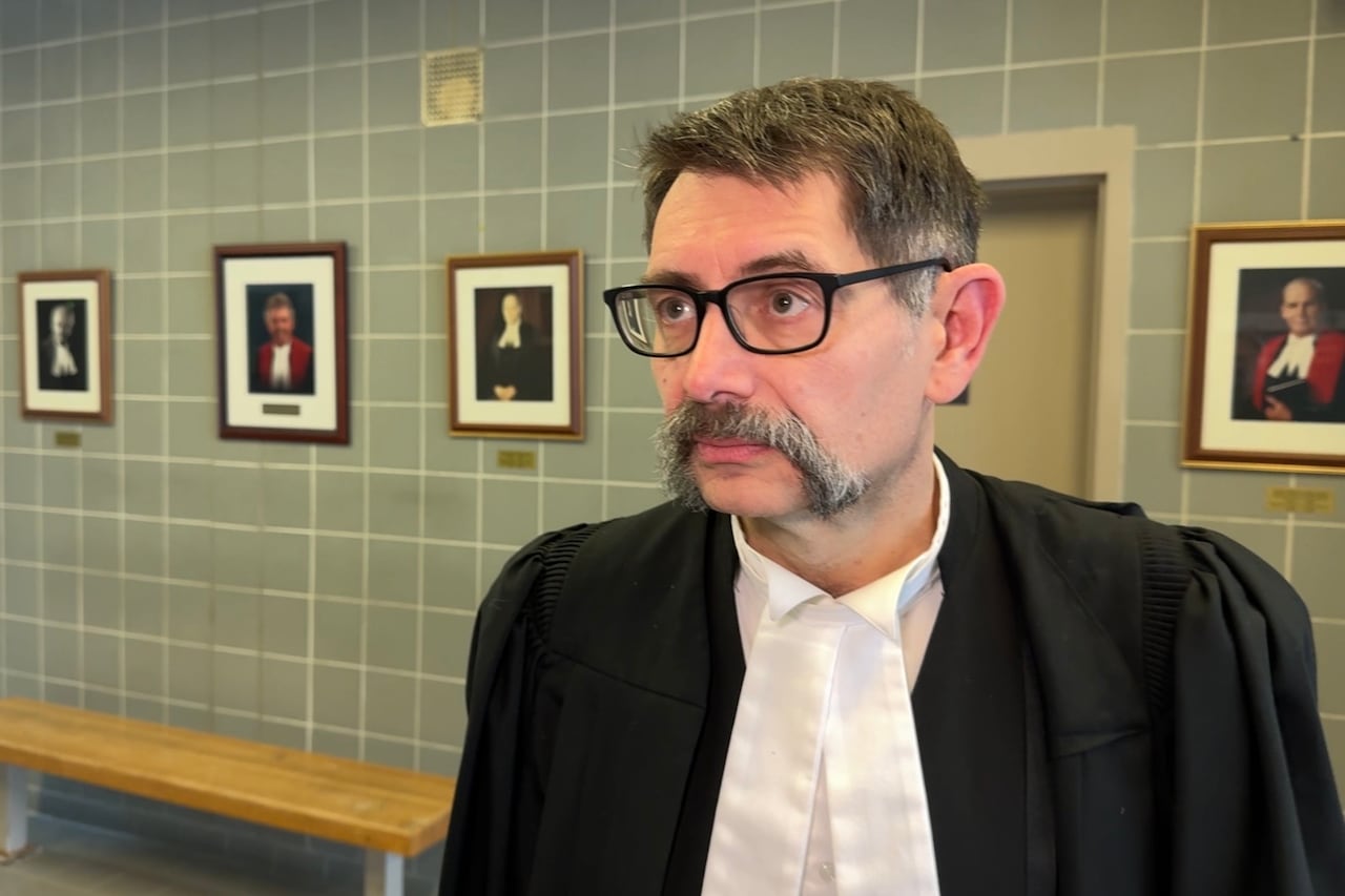 A man with lawyer robes on is shown.