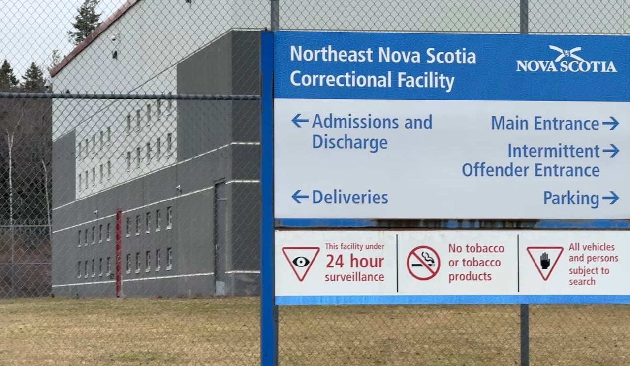 A sign that says Northeast Nova Scotia Correctional Facility is shown, with a fence in the background.