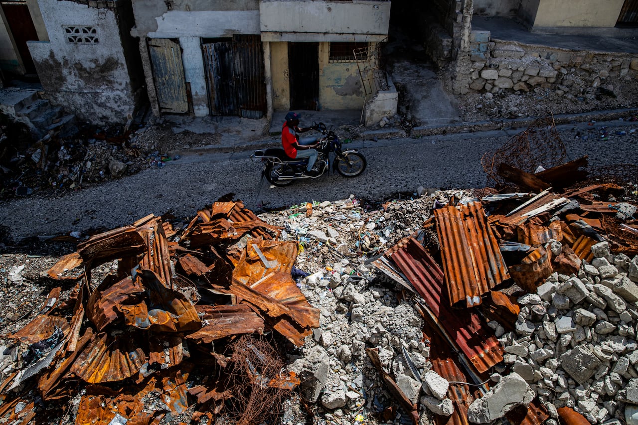A motorcyclist rides through a part of Port-au-Prince's Solino neighbourhood