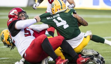 Calgary Stampeders long snapper Aaron Crawford (52) tackles Edmonton Eskimos wide receiver Charles Nelson (4) during first half CFL action in Edmonton, Alta., on Thursday July 7, 2022.