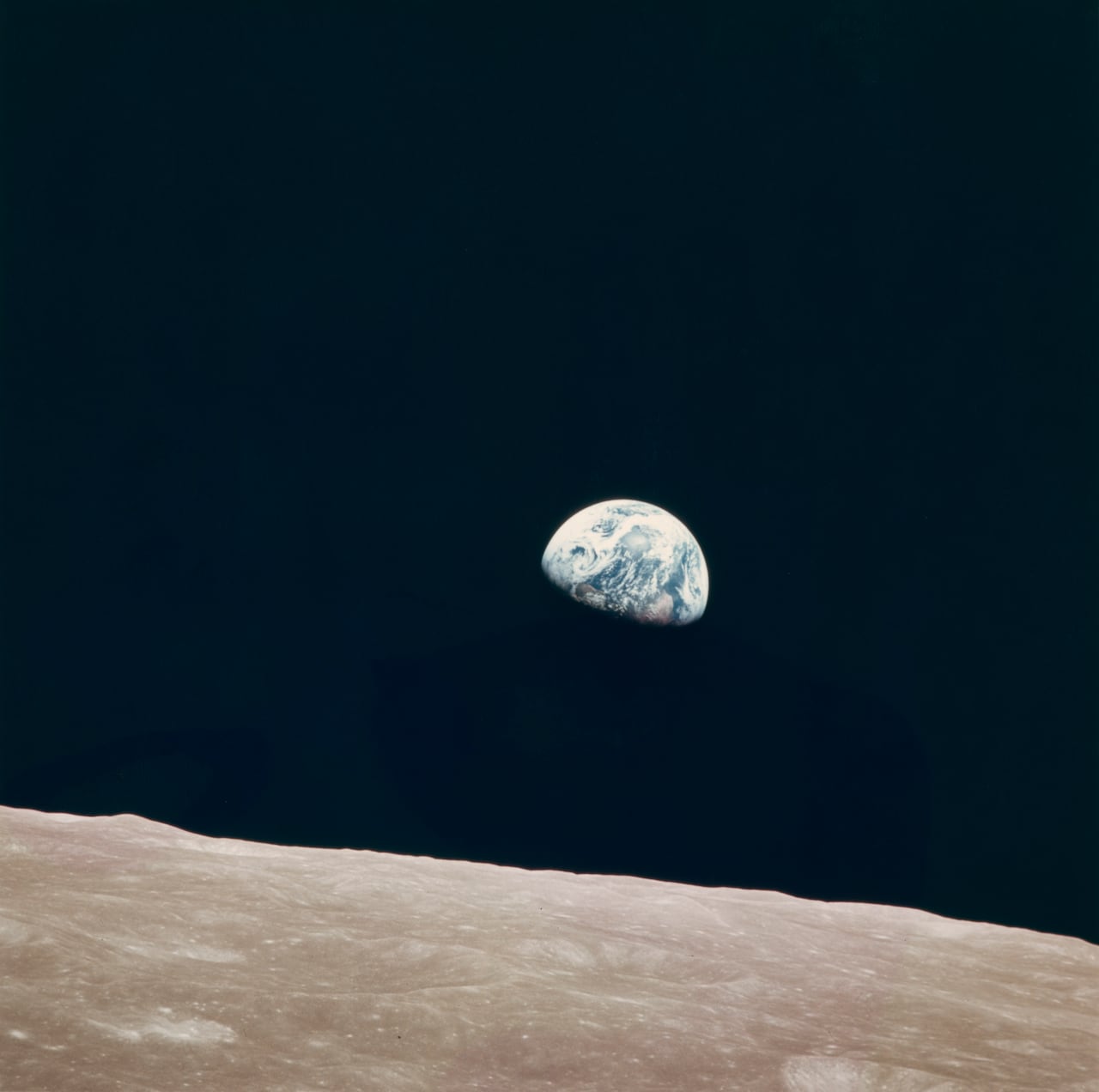 Earth rises over the lunar horizon