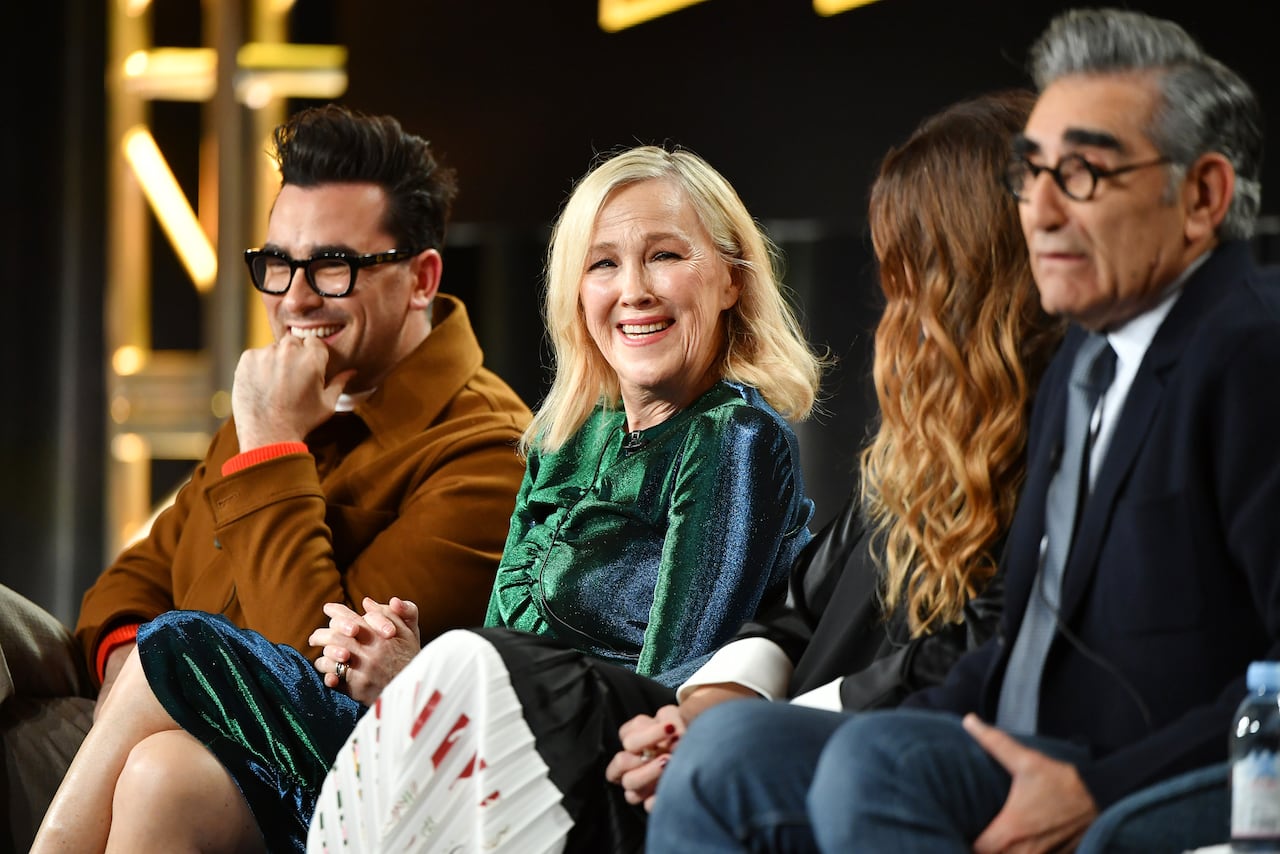 Four people on a panel laughing