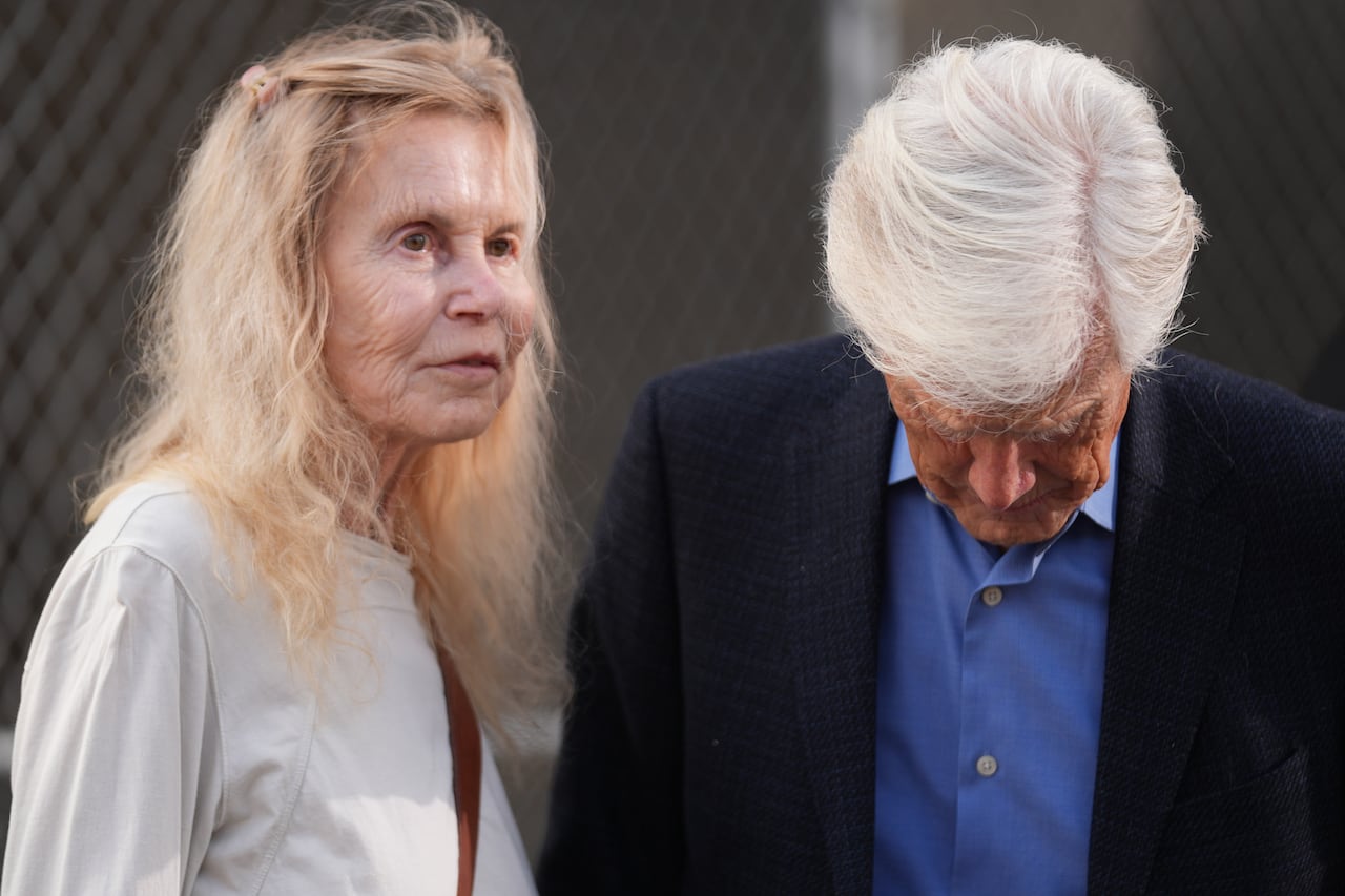 A man and woman appear standing close to one another.