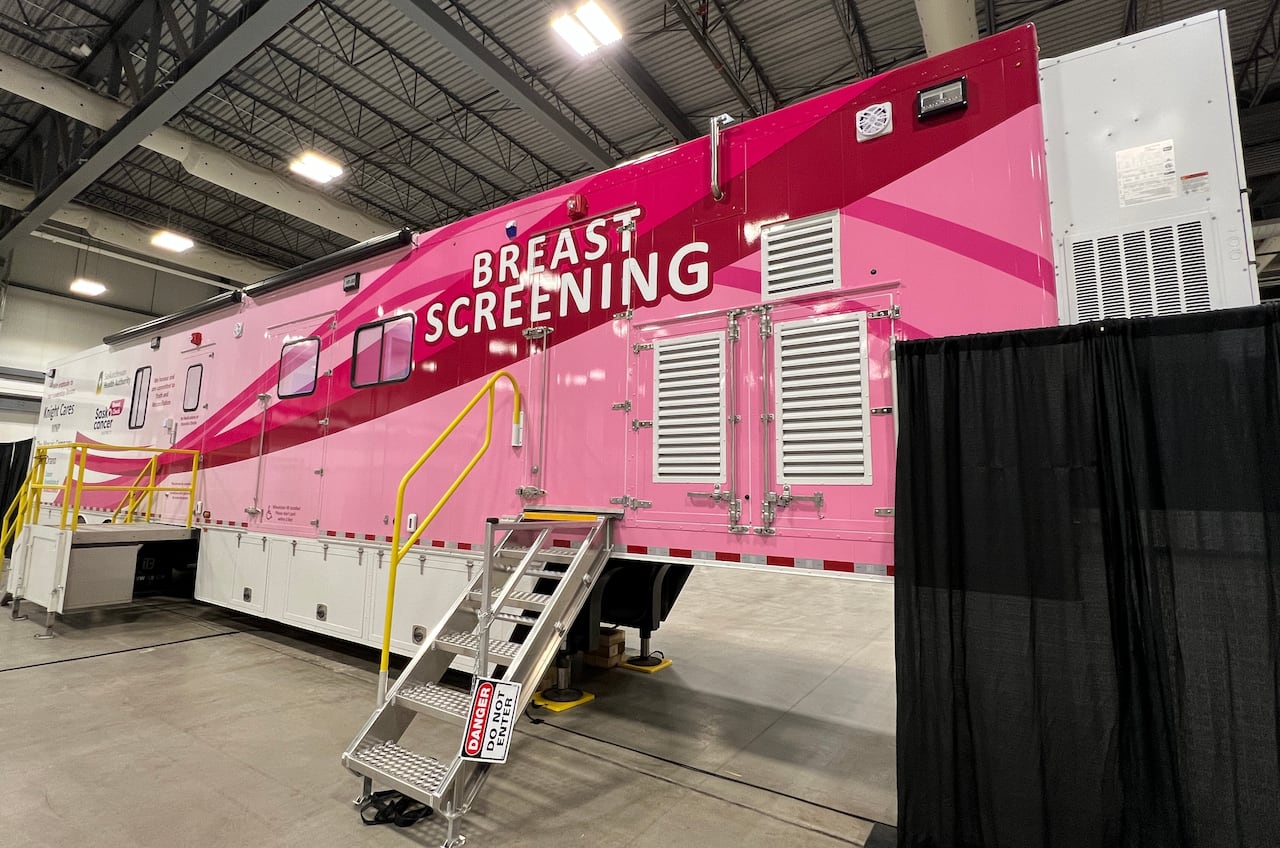 A pink semi trailer with the words breast screening