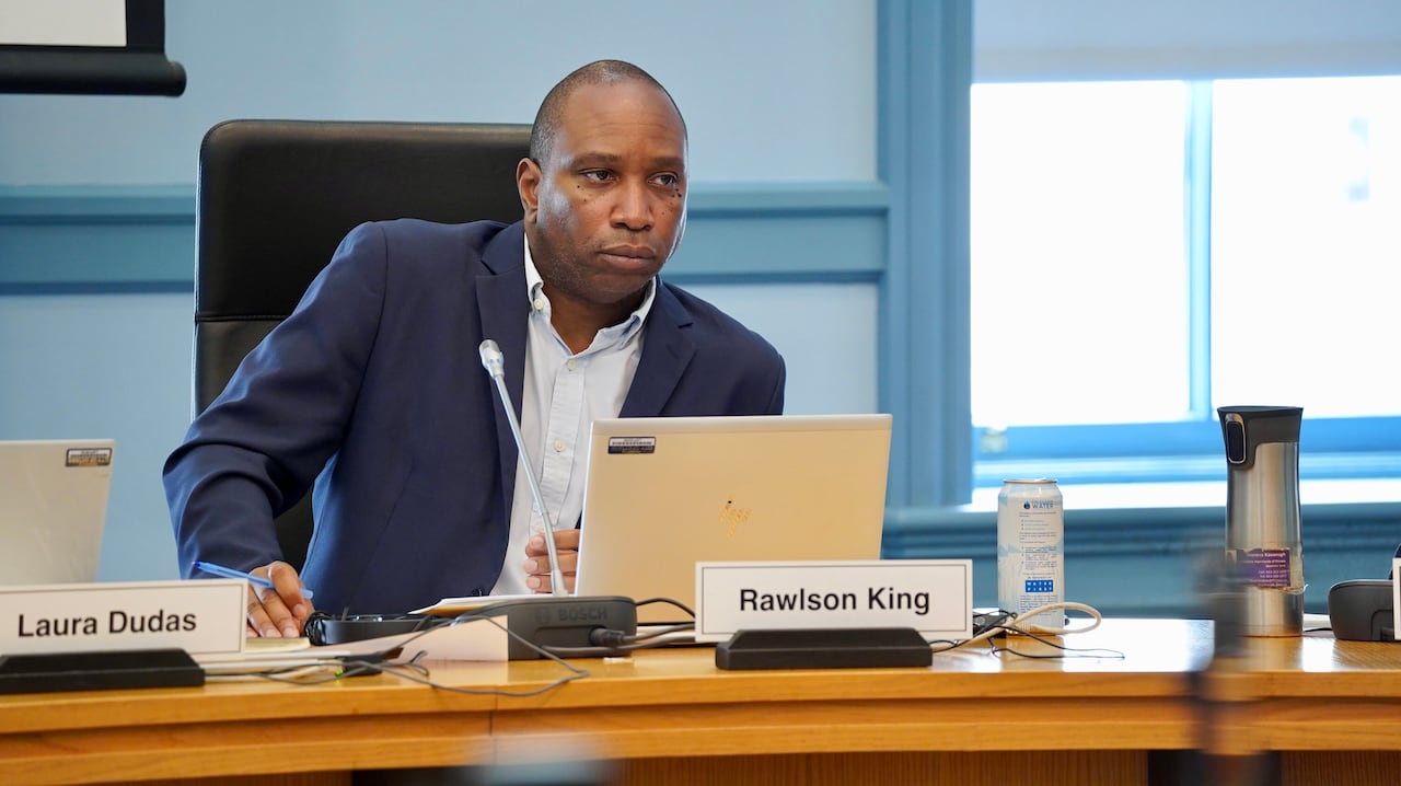 A city councillor listens during a meeting.