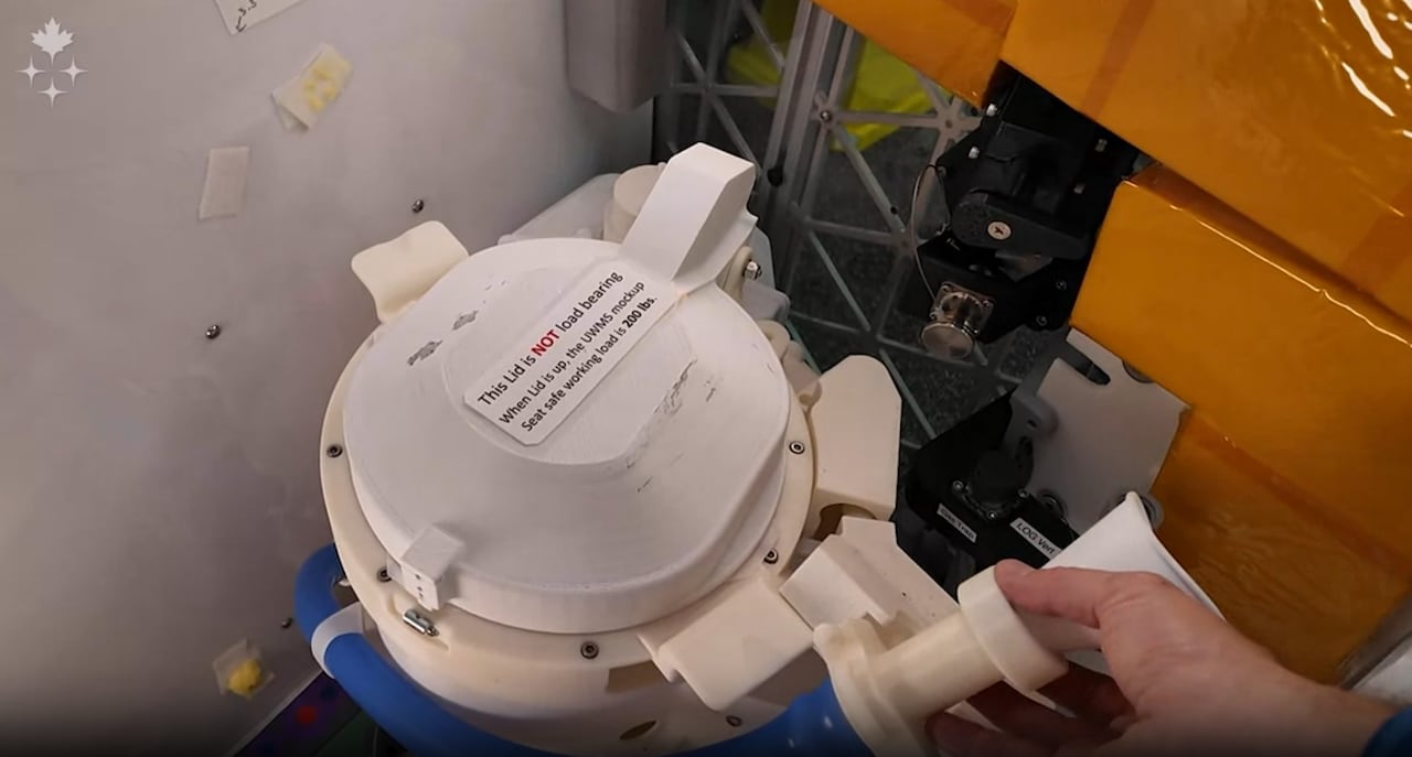 A cylindrical object is seen with someone holding a hose.