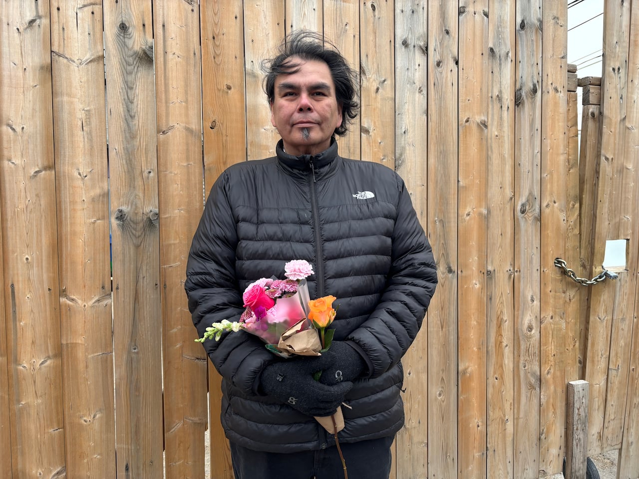 A man holding a bouquet of flowers.