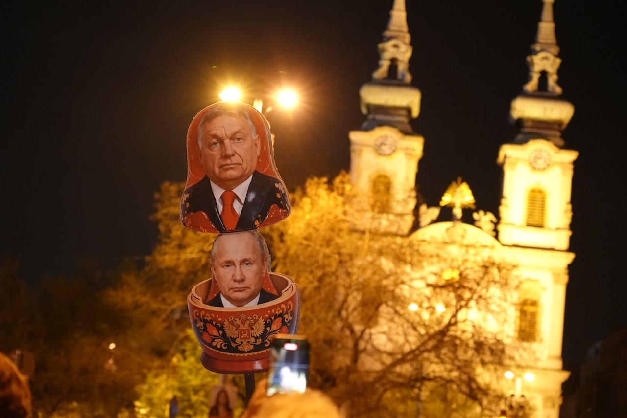 A sign shaped like a Russian nesting doll is seen during a protest.