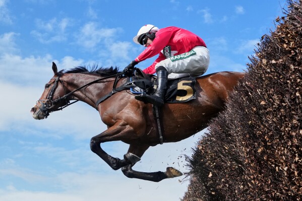 Mirabad ridden by Tristan Durrell clears a fence on the way to winning the Hallgarten & Novum Wines Maghull Novices' Chase during the Grand National horse race meeting at Aintree racecourse in Liverpool, Saturday, April 11, 2026. (AP Photo/Jon Super)